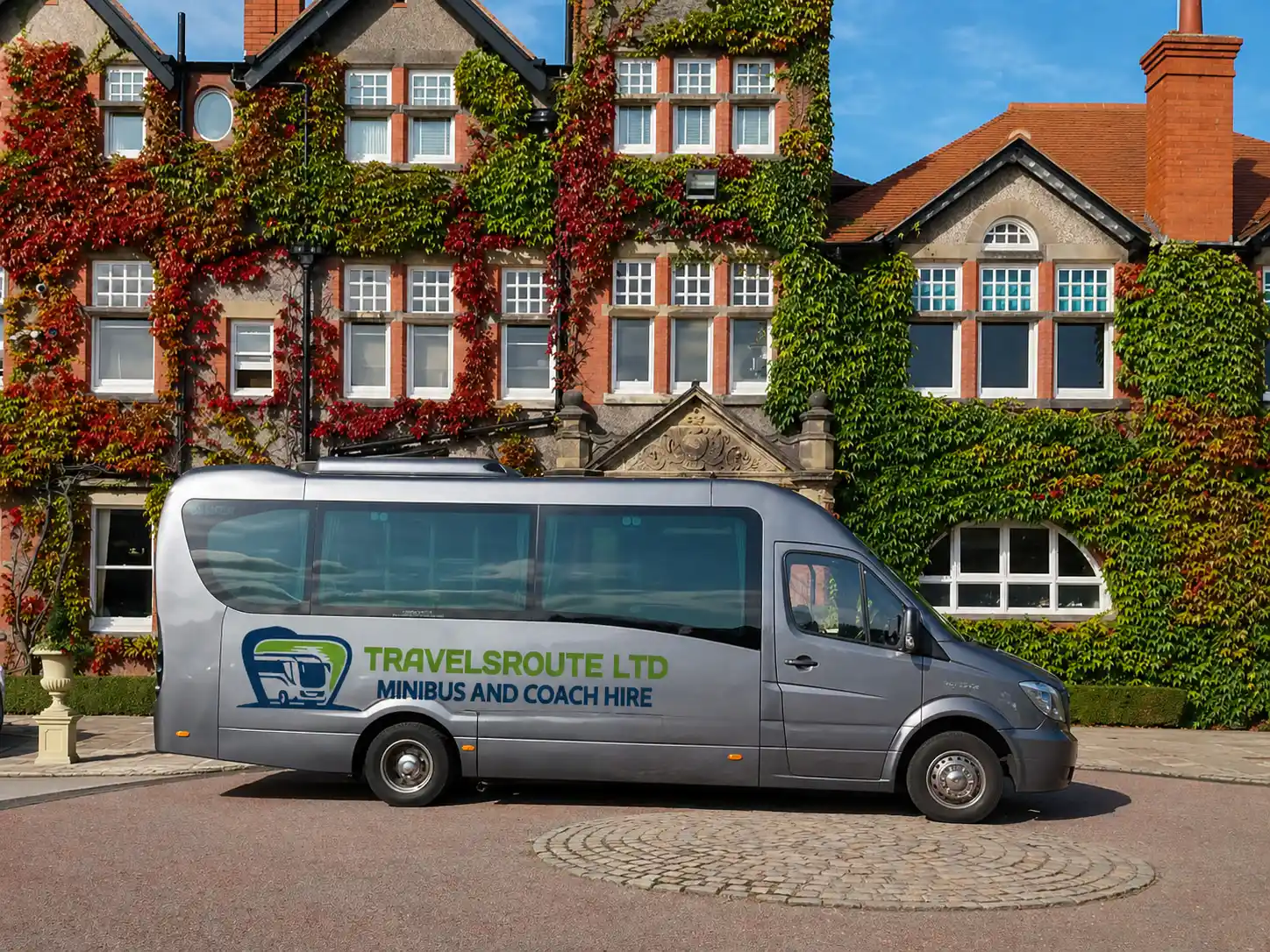 Silver minibus outside an old stone building in a cathedral city like Salisbury