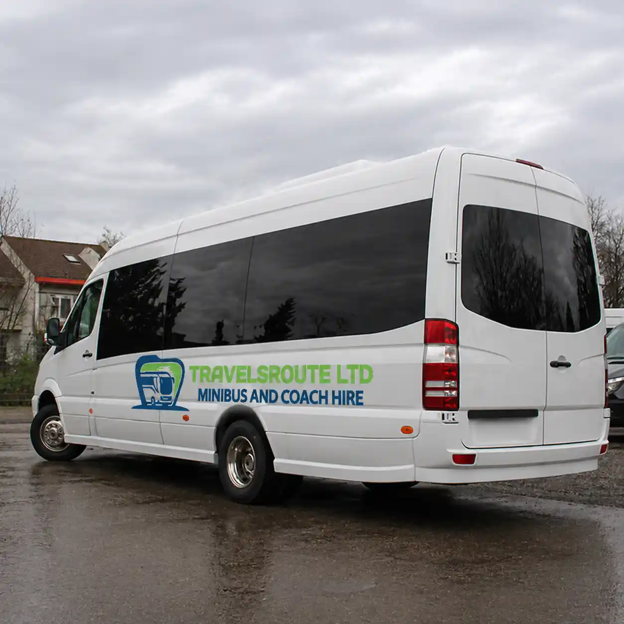 White minibus with its sliding door open, waiting to collect a group in Oldham