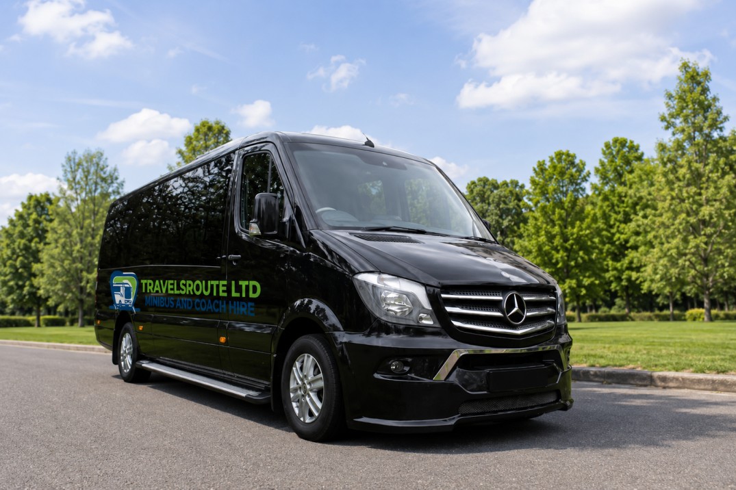 Driver holding a phone beside a minibus, ready to confirm a booking