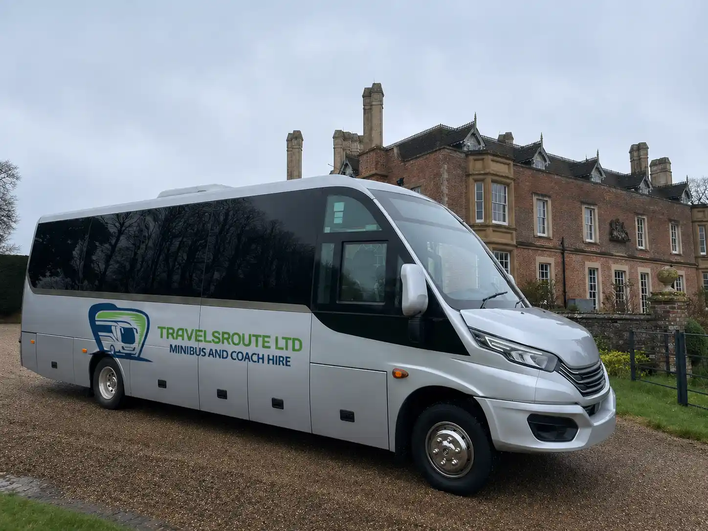 Silver minibus parked outside a red-brick building, ready for a Middlesbrough group pickup