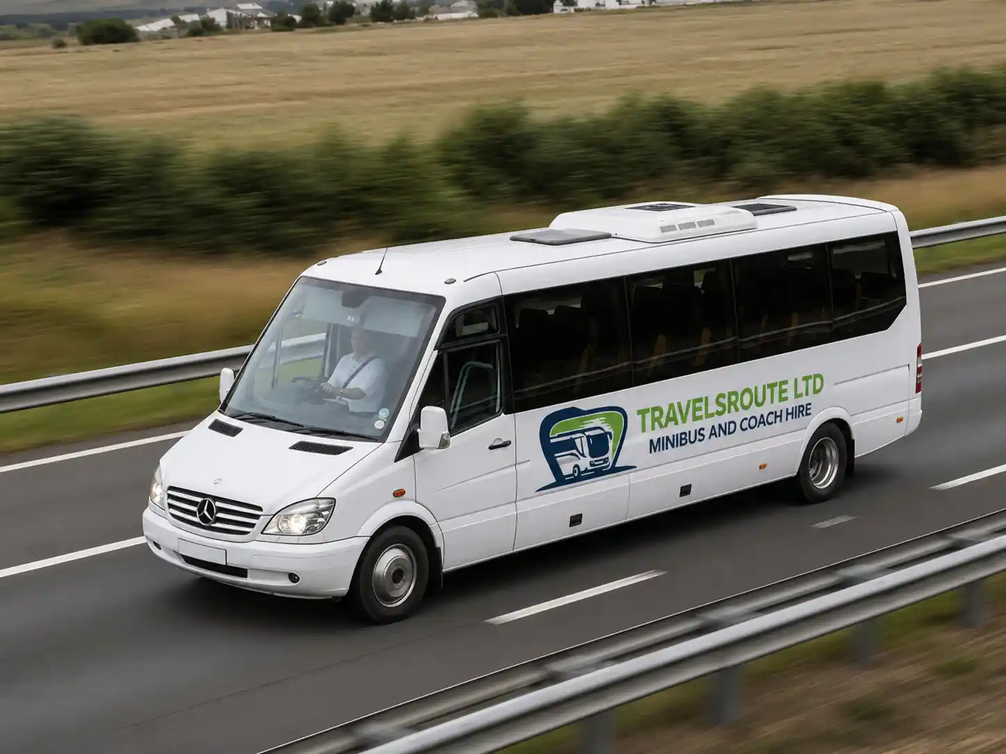 White minibus travelling along a motorway, heading from Sheffield to the airport